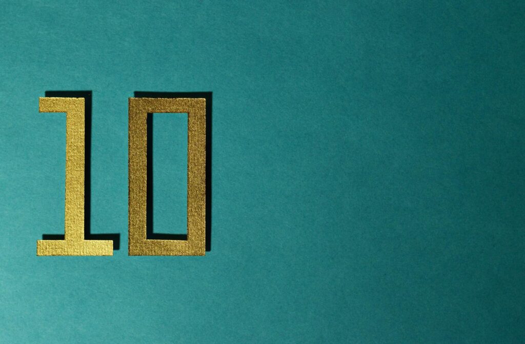 Golden number 10 on a teal background