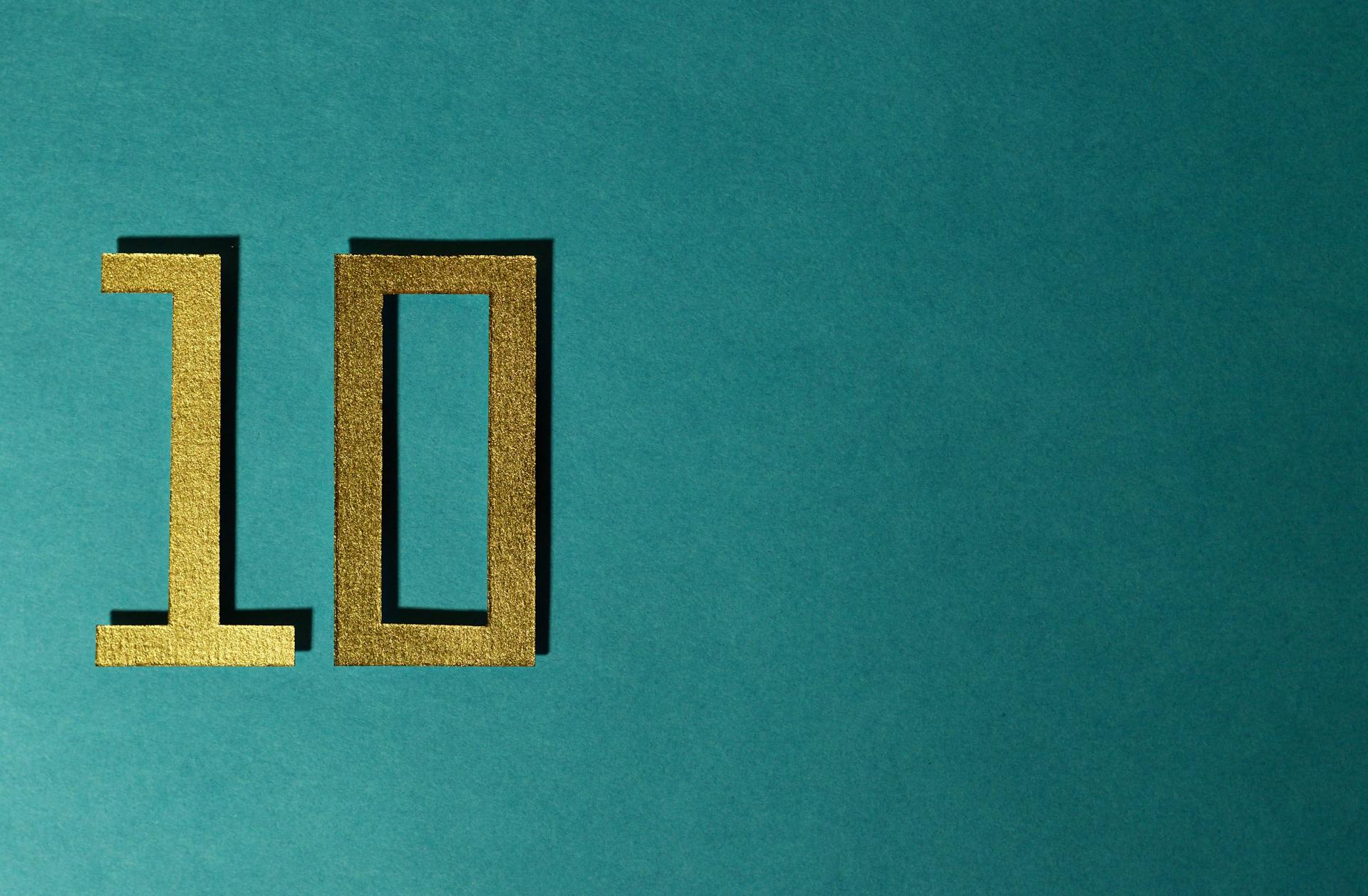 Golden number 10 on a teal background
